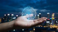 Digital network globe hologram floating above open palm with night city skyline, representing global connectivity, technology innovation, and business communication solutions.