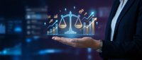 Businessman hand holding glowing scales of justice with financial charts and data analytics icons, representing legal compliance, regulatory standards, and business ethics in digital environment.
