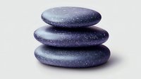 Stacked purple zen stones with galaxy pattern texture creating peaceful spa composition against light background. Wellness and meditation concept.