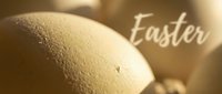 Close-up of natural beige Easter eggs with soft warm lighting and elegant Easter text overlay, perfect for spring holiday greeting cards and seasonal designs.