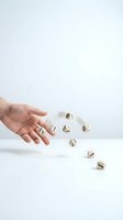 Hand releasing wooden dice with arrows showing direction and movement on white background for business strategy concepts.