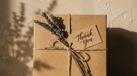 Kraft paper gift box tied with twine and dried lavender, featuring a handwritten thank you tag in warm natural light.