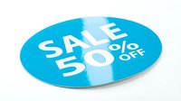 Blue oval sale sticker with 50 percent off text on white background. Promotional discount label for retail marketing and advertising campaigns.