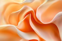 Soft peach and cream colored fabric waves create gentle flowing curves and folds in abstract macro photography composition, highlighting delicate texture and light.