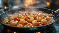 Juicy shrimp sizzling in garlic butter sauce with fresh herbs in black pan, steam rising, close up view of seafood cooking process with warm lighting.