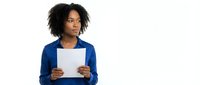 Young African American woman with curly black hair wearing a blue button-up shirt, holding a blank white document or clipboard against white background for business and corporate use.