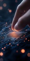 Finger touching glowing microchip on circuit board with orange light particles and bokeh effects against dark background, representing digital transformation and AI technology.