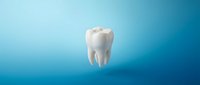 White tooth with crown on blue gradient background for dental care and oral health concepts.