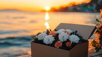 Romantic floral arrangement with white chrysanthemums and peach roses in brown gift box against dramatic ocean sunset background, golden hour lighting creates magical mood.