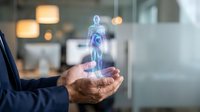 Businessman holding glowing holographic human figure in cupped hands representing healthcare technology, medical innovation and digital wellness solutions.