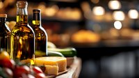 Premium olive oil bottles with fresh cheese and vegetables on wooden board in warm restaurant kitchen setting with bokeh lights.