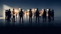 Business team silhouettes standing together against bright light representing unity, leadership and corporate collaboration in professional environment.