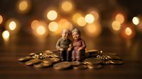 Elderly couple figurines sitting together surrounded by golden coins with warm bokeh lights background representing retirement savings and financial security.