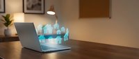 Digital real estate concept with glowing house icons emerging from laptop screen on wooden desk in modern office interior for property technology applications.