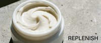 Creamy white moisturizer or skincare product in open jar with swirled texture, ready for cosmetic, beauty, and wellness design projects.