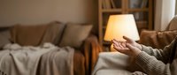 Cozy evening at home with warm lamp light creating comfortable atmosphere in modern living room with soft furnishings and relaxed ambiance for interior design.