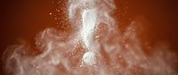 White flour explosion with question mark shape against warm brown background creating dramatic dust cloud effect for culinary and baking concepts.