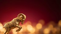 Golden ornamental ram figurine with intricate carved details against warm bokeh background, suitable for luxury branding, wealth symbolism, and decorative design projects.