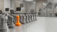 Orange pawn standing out among gray pawns on chessboard in modern office setting, representing leadership, uniqueness, and strategic business advantage.