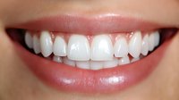 Close up of bright white healthy teeth with pink lips showing natural smile, suitable for dental care and oral hygiene advertising or healthcare promotion.