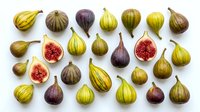 Fresh figs collection with whole and sliced fruits showing red flesh, various colors from green to purple, isolated on white background for culinary designs.