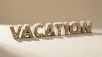 Vacation word made of sand and seashells on beige background, summer holiday concept for travel banners and greeting cards.