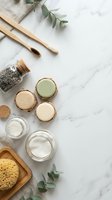 Natural eco-friendly bathroom essentials with bamboo toothbrushes, organic soap bars, sea salt scrub and eucalyptus on marble background for sustainable living.