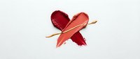 Heart-shaped lipstick smears in red and coral shades on white background. Cosmetic texture for beauty and makeup concepts.