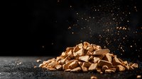 Crushed milk chocolate pieces in pile with cocoa powder dust floating against dark background, dramatic food photography for confectionery advertising.