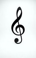 Black treble clef musical symbol isolated on white background for music education, sheet music design, and creative projects.