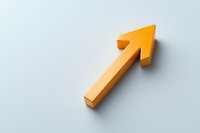 Orange diagonal arrow pointing upward on light gray background casting soft shadow, minimalist business concept for growth and success.
