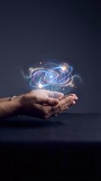 Hand holding glowing atomic structure with orbiting electrons and luminous particles against dark background, representing science, innovation, and technology concepts for educational and corporate use.