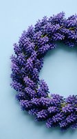 Fresh lavender wreath on soft blue background for aromatherapy, home decor and natural wellness concepts. Handcrafted floral arrangement for relaxation.