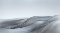 Abstract flowing waves of silver and white create a smooth, undulating surface with soft gradients and elegant curves, suitable for modern design backgrounds and contemporary visual projects.