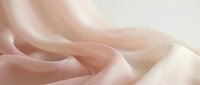 Soft flowing pink silk fabric with elegant drapes and gentle curves creating luxurious textile waves for fashion and interior design projects.