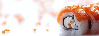 Fresh salmon sushi roll with rice, nori and red caviar garnish on white background, macro close-up view showing texture and detail of Japanese cuisine.