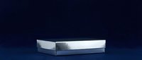 White open box on dark blue surface with dramatic lighting and shadow, suitable for product mockups, packaging design, and commercial advertising.