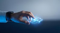 Businessman hand holding glowing digital smartphone with futuristic holographic interface, representing mobile technology innovation and wireless communication for business applications.