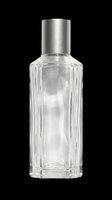 Empty glass perfume bottle with silver metallic cap, isolated on transparent background. Ready for design use on product packaging, labels, cosmetics branding, print-on-demand items, and digital beauty graphics.