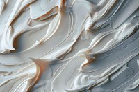 Creamy white frosting swirls and peaks create abstract waves and textures against light background, macro photography showing rich, smooth culinary details.