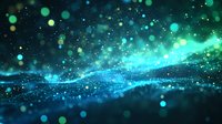 Magical glowing particles flow in turquoise and green waves against dark background, creating ethereal bokeh effect and shimmering cosmic atmosphere.