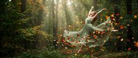 Young woman in flowing dress dancing gracefully among autumn leaves in enchanted forest with golden sunlight streaming through trees creating magical atmosphere.