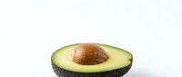 Fresh ripe avocado half with pit on clean white background, healthy organic fruit isolated for culinary design and nutrition content.