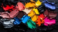 Vibrant oil paint smears and smudges in multiple colors on black background, showing rich texture and artistic palette. Macro photography of colorful paint swatches.