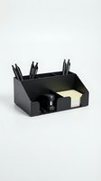 Black desk organizer with pen holders, sticky note pad dispenser and storage compartments isolated on white background for office organization and workspace design.