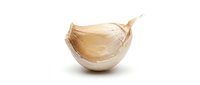 Garlic clove with papery skin isolated on white background, ready for culinary and food design projects.