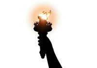 Silhouette of raised hand holding flaming torch against bright glowing light, symbolizing hope, freedom, victory, and enlightenment for leadership and inspiration concepts.