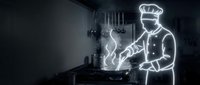 Professional chef cooking in modern kitchen with neon light effect outline glowing white against dark background for culinary design projects.