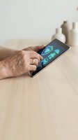 Senior hands using tablet with digital health icons on wooden table for telemedicine consultation and healthcare technology applications.