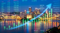 Urban skyline with financial data overlay showing rising stock market trends and economic growth indicators at night.